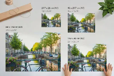 Photo canvas featuring a canal with a bridge, trees, buildings, a bicycle, and flowers
