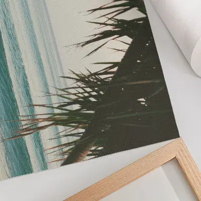 Decorative canvas print featuring a peaceful beach scene with surfing waves and palm trees