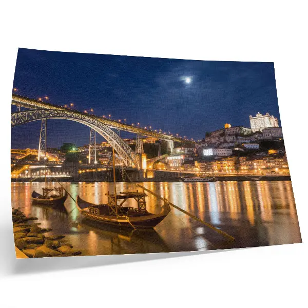 Poster bridge at night with city lights, water, and boats