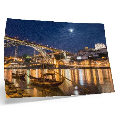Poster bridge at night with city lights, water, and boats