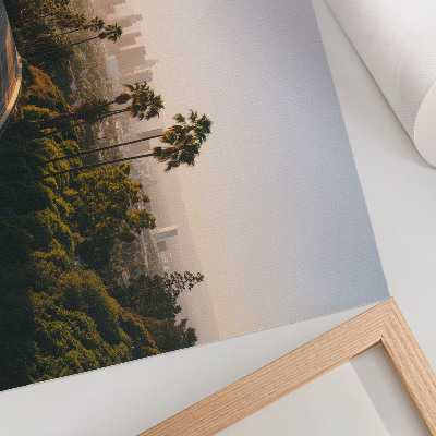 Photo canvas Palm trees and the city skyline in the sunshine