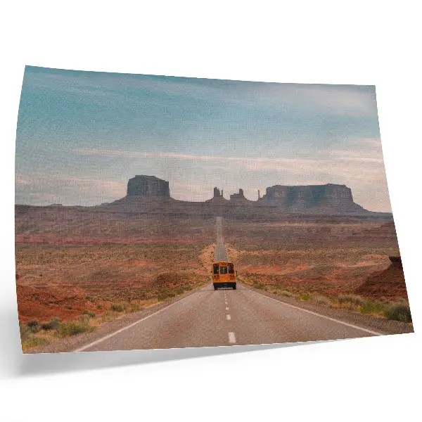 Decorative canvas print a straight road with monumental mountains in warm colors