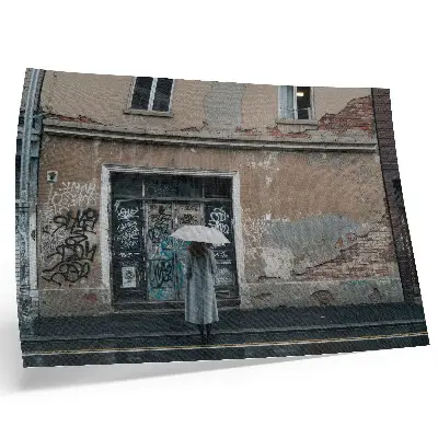 Decorative canvas print a person with an umbrella in front of a graffiti wall