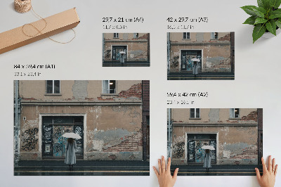 Decorative canvas print A person with an umbrella in front of a wall full of graffiti