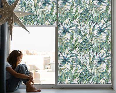 Fabric roller blind with a tropical leaves pattern