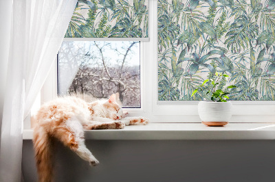 Fabric roller blind with a tropical leaves pattern