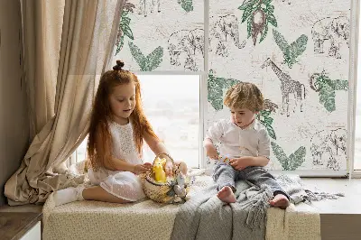 Blackout roller blind with a giraffes, elephants and leaves pattern