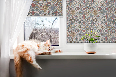 Fabric roller blind for window with decorative rhombuses pattern
