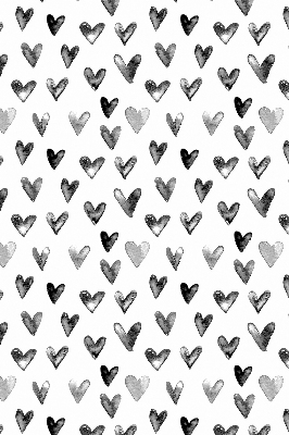 Blackout roller blind for window with black hearts pattern