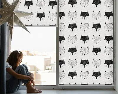 Blackout roller blind for window with a drawn fox heads pattern