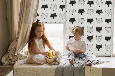 Blackout roller blind for window with a drawn fox heads pattern