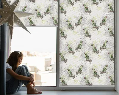 Fabric roller blind for window with parrots on a branch pattern