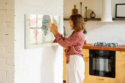 Magnetic glass dry erase board featuring a world map made from letters