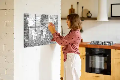 Magnetic glass dry erase board featuring a world map on a brick background
