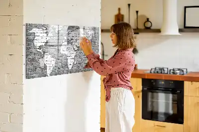 Magnetic glass dry erase board featuring a world map on a brick background