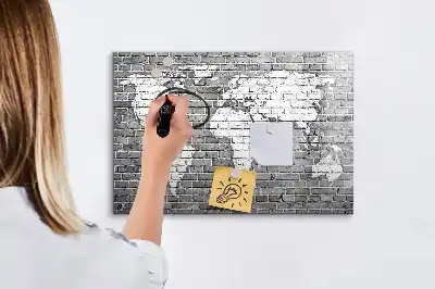 Magnetic glass dry erase board featuring a world map on a brick background