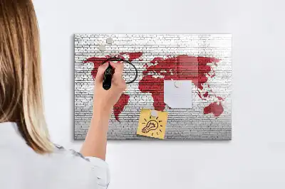 Magnetic marker board world map on a brick wall
