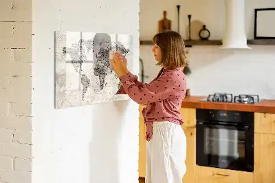 Magnetic marker board featuring a world map made from newspapers