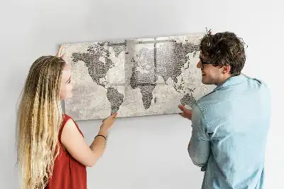 Magnetic marker board featuring a world map made from newspapers
