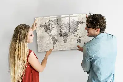 Magnetic marker board featuring a world map made from newspapers