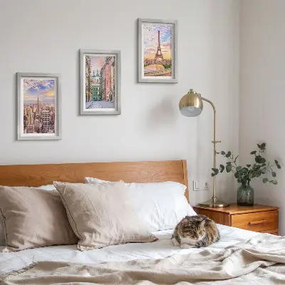 Photo frame wall featuring views of New York, Paris, and Warsaw at dusk