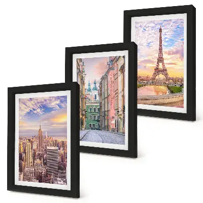 Photo frame wall featuring views of New York, Paris, and Warsaw at dusk