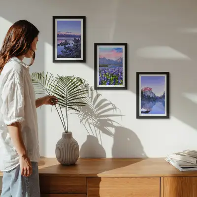 Framed triptych mountain landscapes featuring water, sky, and a field of flowers
