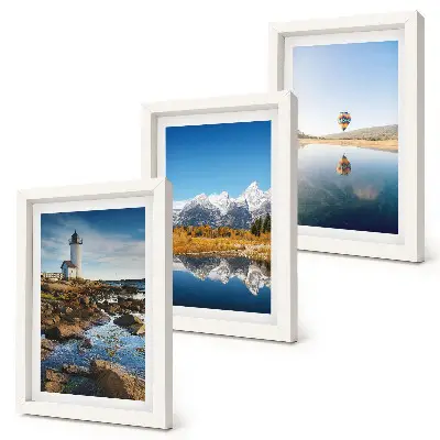 Photo frame wall featuring views of nature with a lighthouse, mountains, lake, and a balloon