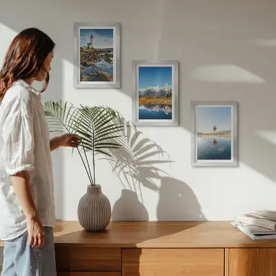 Photo frame wall featuring views of nature with a lighthouse, mountains, lake, and a balloon