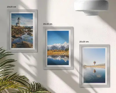 Photo frame wall featuring views of nature with a lighthouse, mountains, lake, and a balloon