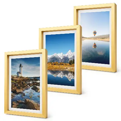 Photo frame wall featuring views of nature with a lighthouse, mountains, lake, and a balloon