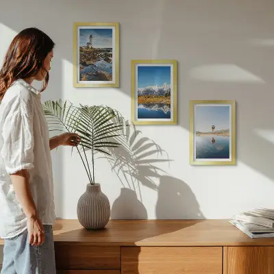 Photo frame wall featuring views of nature with a lighthouse, mountains, lake, and a balloon