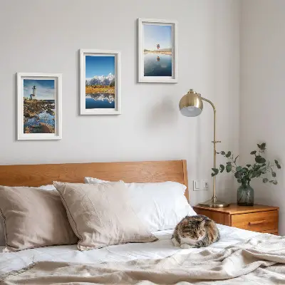 Photo frame wall featuring views of nature with a lighthouse, mountains, lake, and a balloon