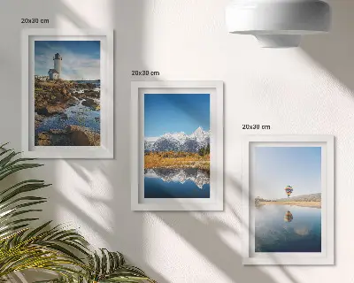 Photo frame wall featuring views of nature with a lighthouse, mountains, lake, and a balloon