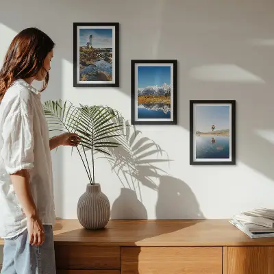 Photo frame wall featuring views of nature with a lighthouse, mountains, lake, and a balloon