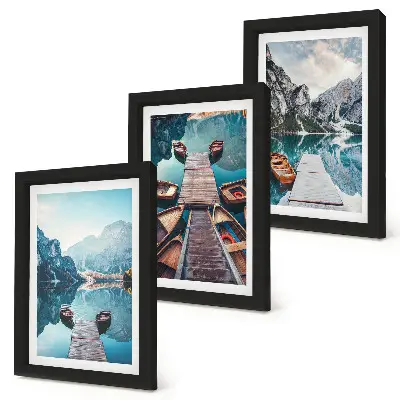 Photo frame wall featuring a calm lake with wooden piers and boats