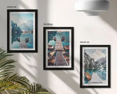 Photo frame wall featuring a calm lake with wooden piers and boats