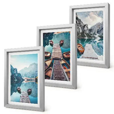 Photo frame wall featuring a calm lake with wooden piers and boats