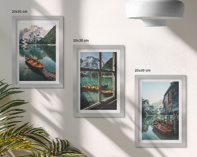 Framed triptych View of a mountain lake with boats and a house by the water