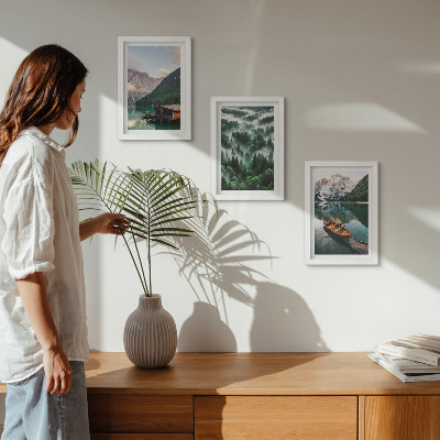 Photo frame wall Mountain landscapes with a lake, a boat, and a forest in the fog