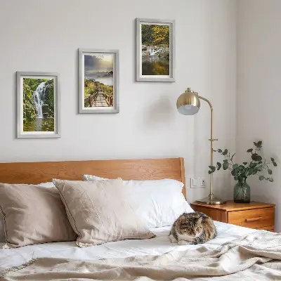 Framed triptych wall art featuring waterfalls, mountains, cloud paths, and autumn views