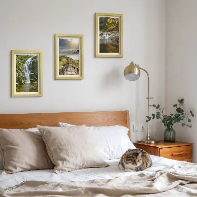 Framed triptych wall art featuring waterfalls, mountains, cloud paths, and autumn views