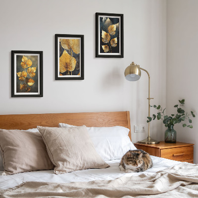 Framed triptych Leaves in shades of yellow on a dark background