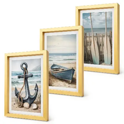 Framed triptych boat anchor and oars on a beach with the sea