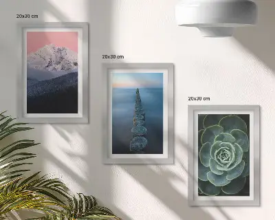 Framed triptych mountains with a pink sky, water, and green succulents