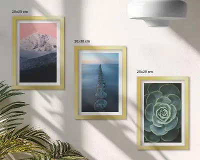 Framed triptych mountains with a pink sky, water, and green succulents