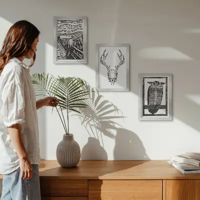 Photo frame wall featuring a graphic Scream-inspired skull and owl illustration