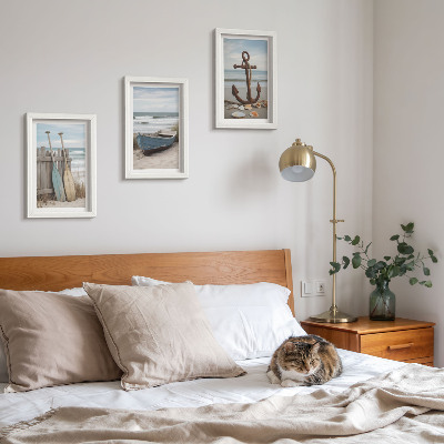 Photo frame wall A beach with a rowboat and an anchor in the sand