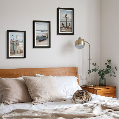 Photo frame wall A beach with a rowboat and an anchor in the sand
