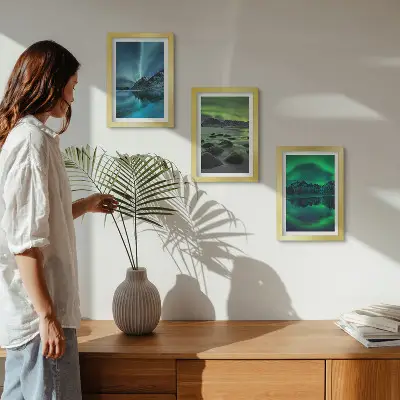 Photo frame wall with a winter landscape featuring northern lights and mountains